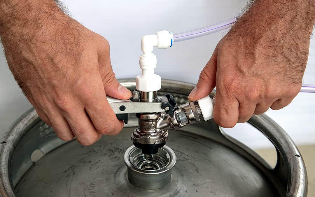 The hands hold the pusher swivel head on the beer above the keg and show how the keg of beer is bumping.