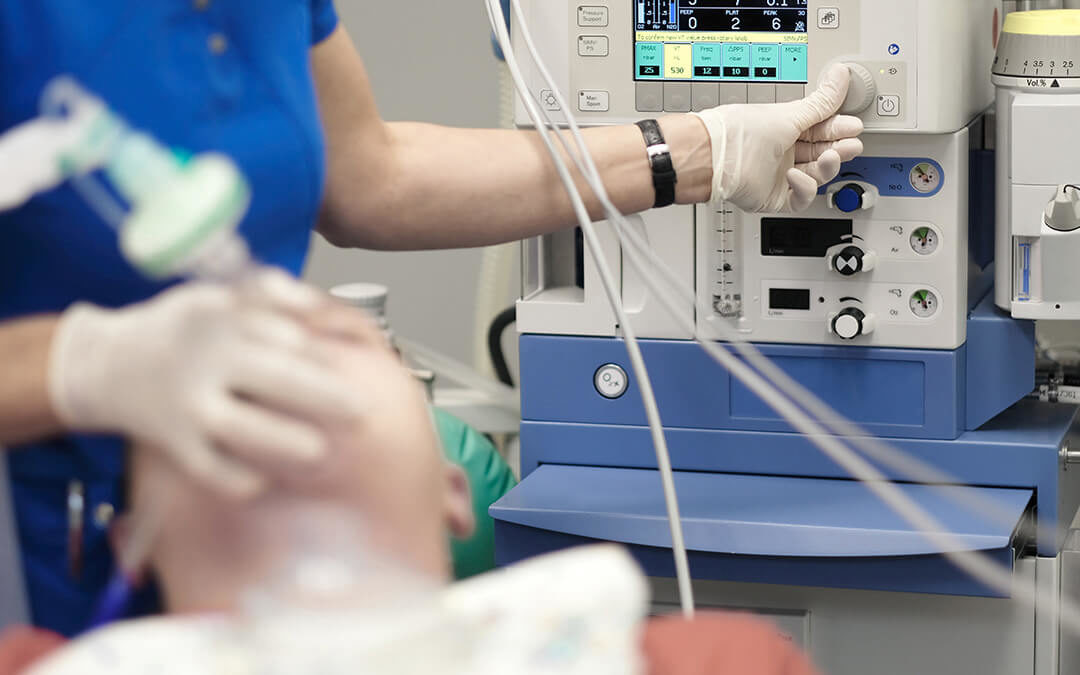 An anesthesiologist monitors the condition of a patient under general anesthesia