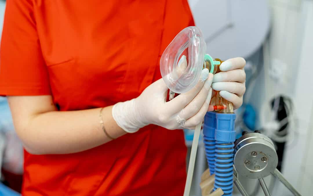 Breathing anaesthesiology face mask held in hands in latex transparent gloves. 