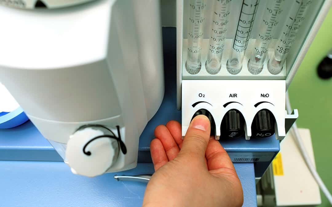 Doctor adjusts the parameters of medical rotameter on the anesthetic set