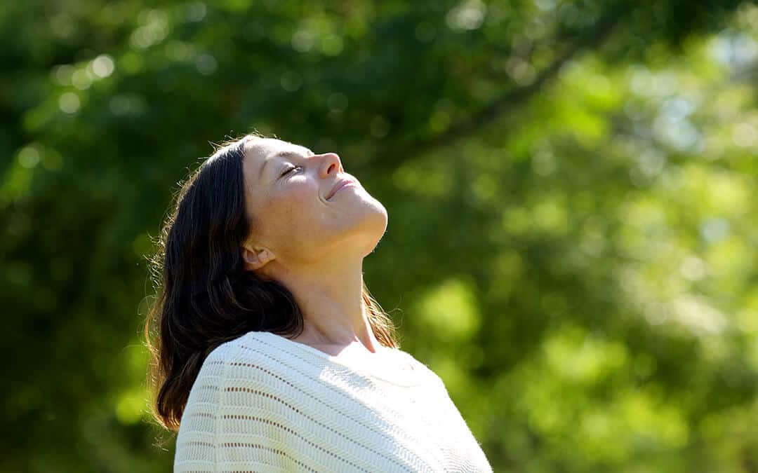 Middle age woman breathing fresh air in the park
