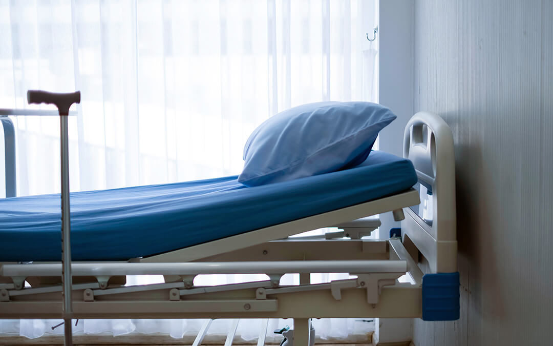 Manual adjustable hospital bed in hospital room.