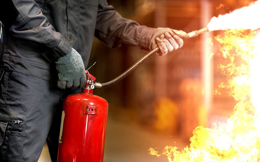 Man using fire extinguisher fighting fire