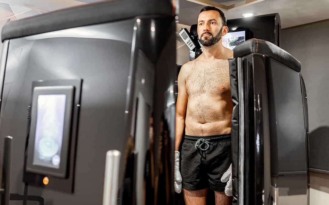 A man standing in a chamber for whole body cryotherapy