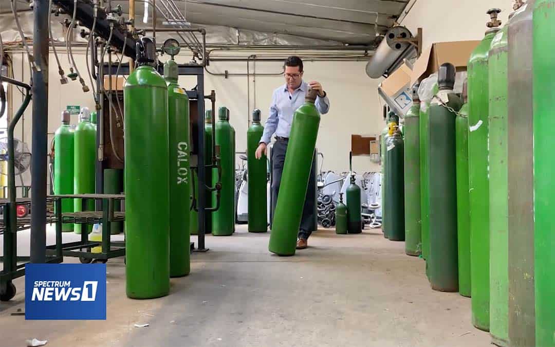 Steve Yaeger of CalOx walking through room of green gas tanks