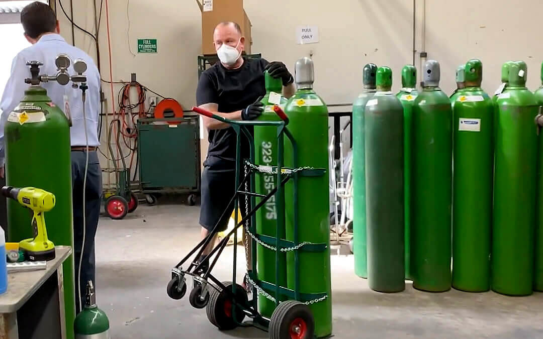 Calox warehouse with a room full of green oxygen tanks