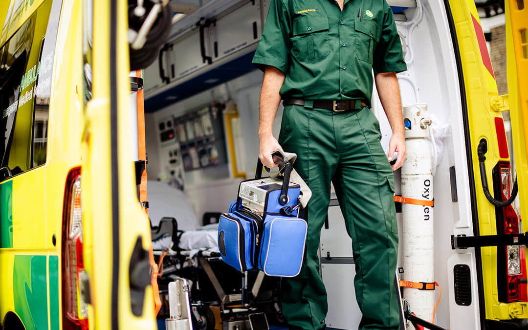 EMS technician carrying oxygen supplies