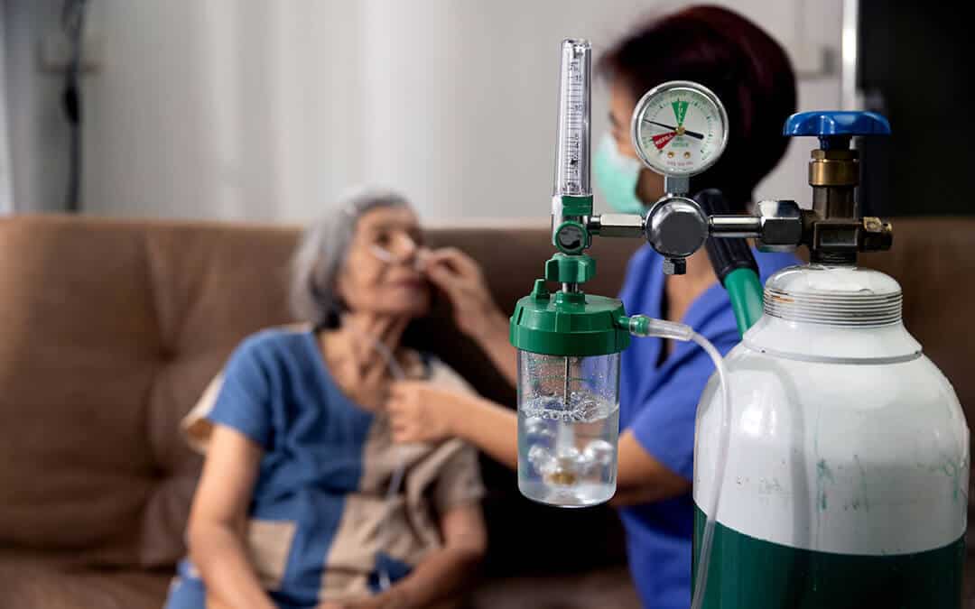 High-flow oxygen therapy for COVID patients - senior woman receiving oxygen