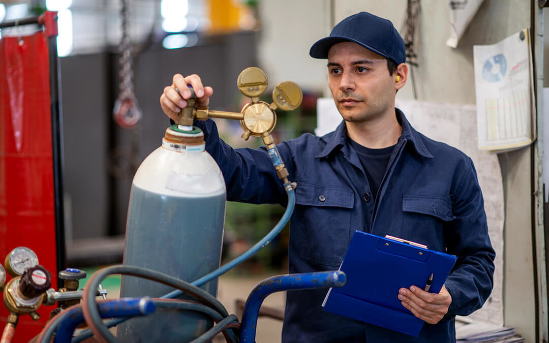 Man checking gas cylinder for safety