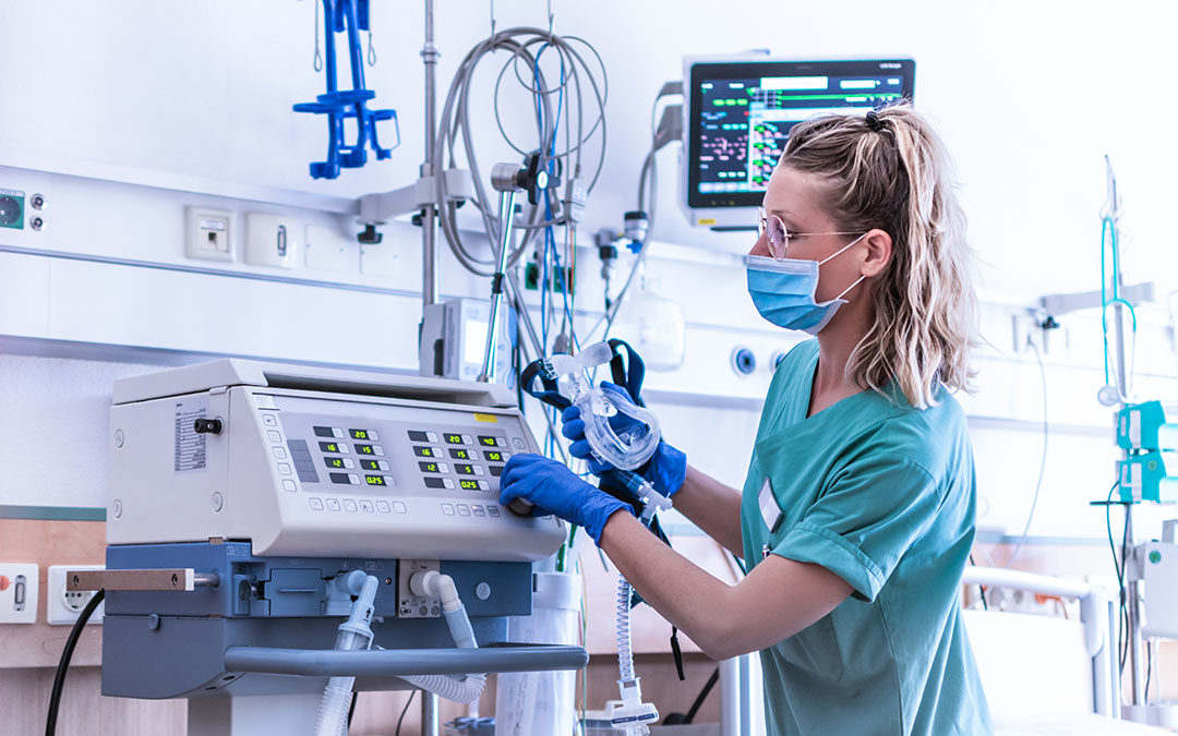 Nurse monitoring oxygen levels on a machine