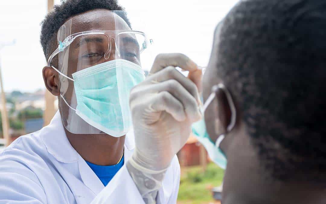 lab scientist taking nasal sample from a man