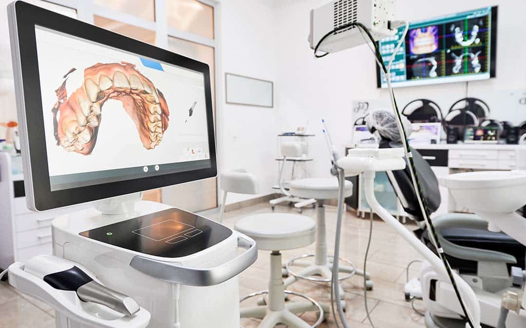 Dentist office with a screen showing a 3D render of a person's upper teeth and gums