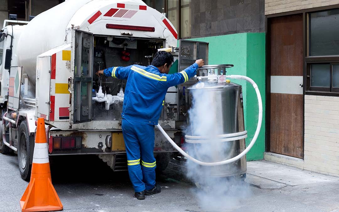 Liquid Nitrogen in relation to Cryogenics: Man loads a tank from a truck