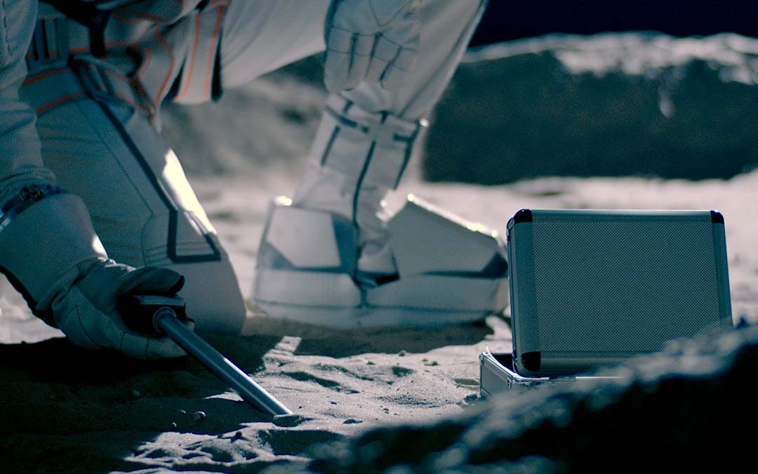 Astronaut inspecting moon dust