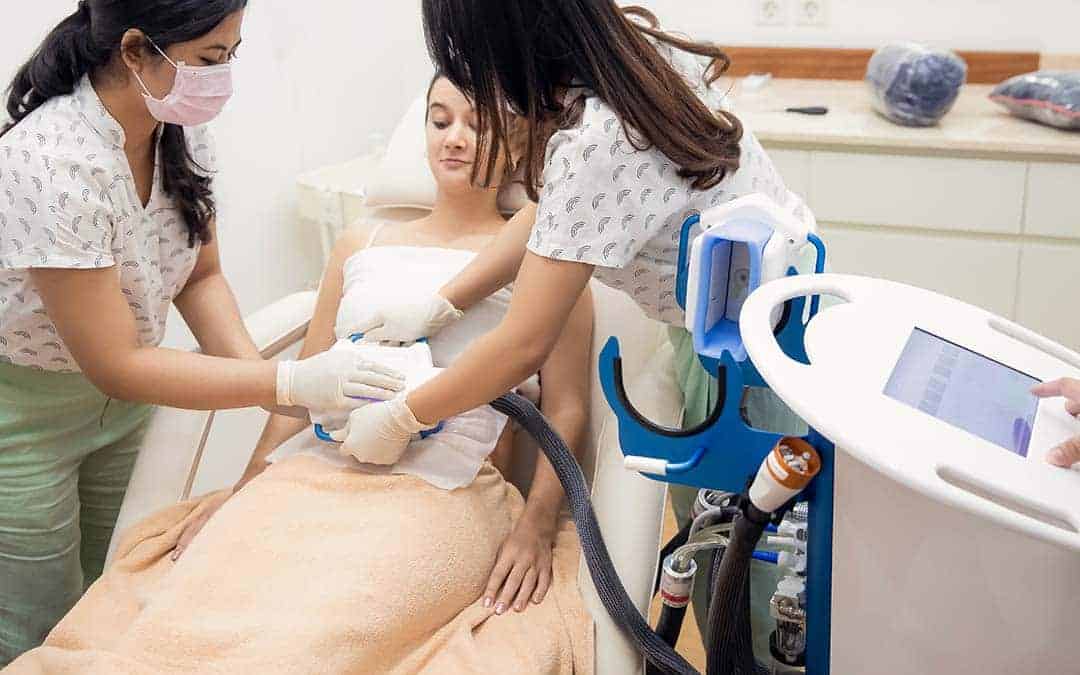 Cryotherapy machine on girl's stomach