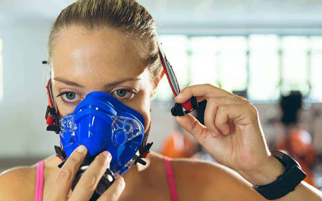 woman holding an oxygen mask to her face