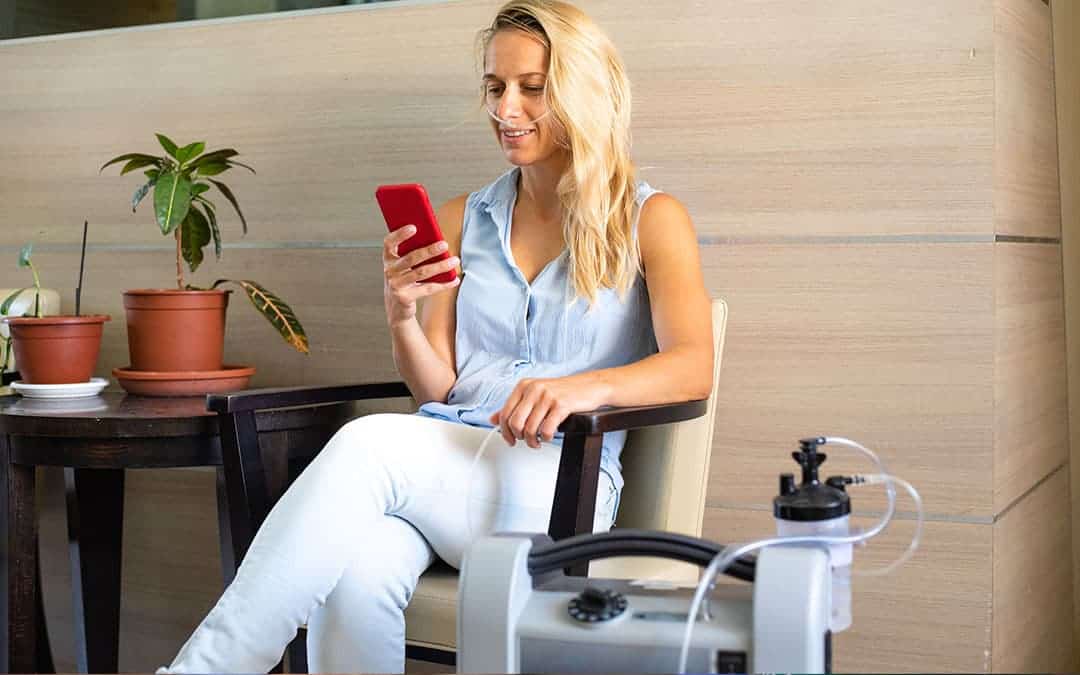 use of portable oxygen containers at home - blonde woman relaxing with oxygen tube in her nose