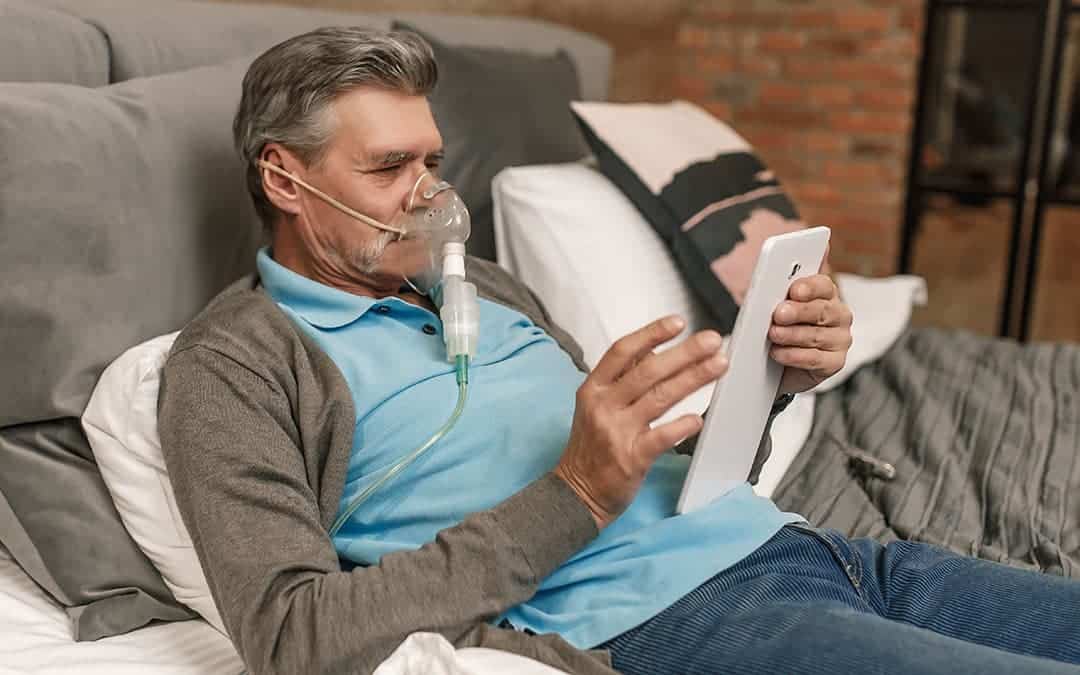 man wearing an oxygen mask while relaxing on the couch