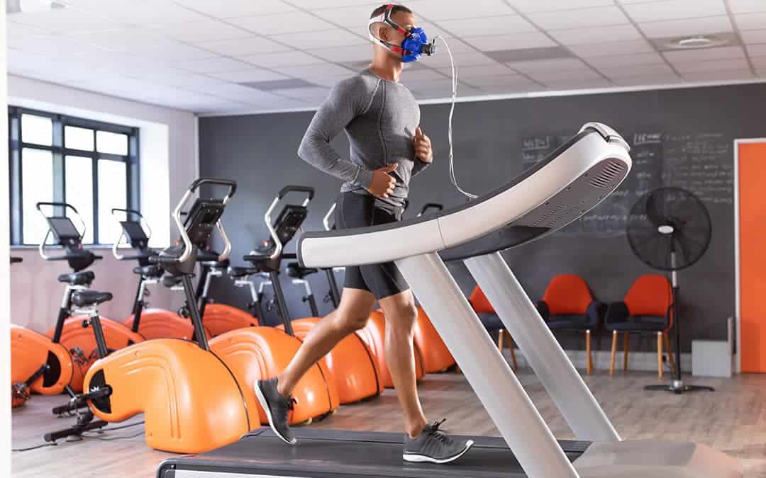 fit man funning on a treadmill with an oxygen mask on