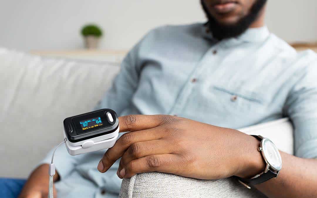 man with a pulse oximeter on his finger